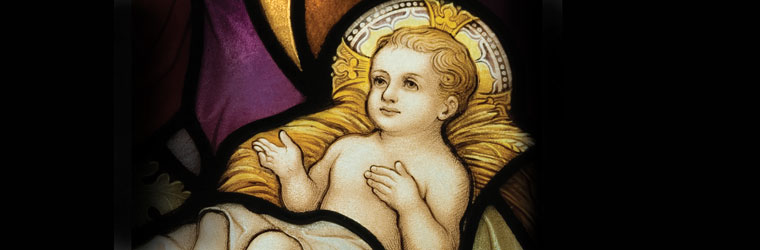 Baby Jesus in a manger stained glass window
