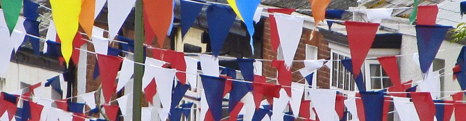 Bunting strung from houses across the street for a party